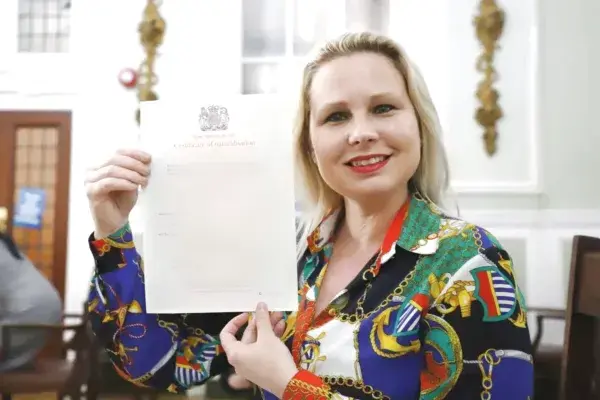 Teacher Gra con su certificado de docencia del Reino Unido